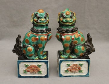 PAIR CHINESE POLYCHROME AND GILT DECORATED FIGURES OF FU DOGS SEATED ON RECTANGULAR BLOCKS.