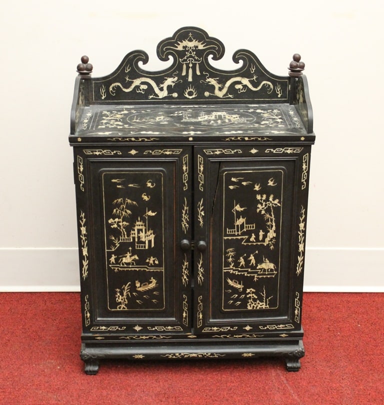 CHINESE BONE-INLAID EBONIZED WOOD TWO-DOOR CABINET. - H: 23 1/2; W: 15 3/4"; D: 7 3/4".: CHINESE BONE-INLAID EBONIZED WOOD TWO-DOOR CABINET. Top has three quarter gallery and shaped crest; panels of figures in pavilions. Interior fitted with shelves and drawers. - H: 23 1/2; W: 15 3/4";