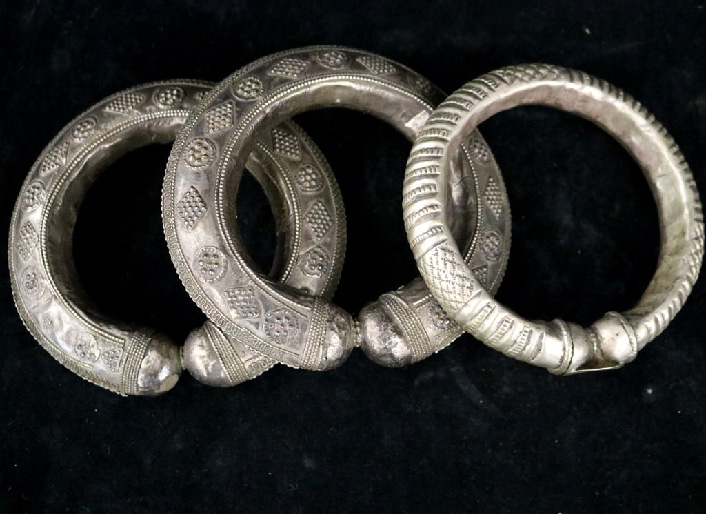 CENTRAL ASIAN TRIBAL PENDANTS ,: CENTRAL ASIAN TRIBAL PENDANTS . Set of three ornate ankle bracelets, often referred to as "anklets," "anklets," or "payal" in South Asian cultures. They lack a hinge or openable closure. The surface