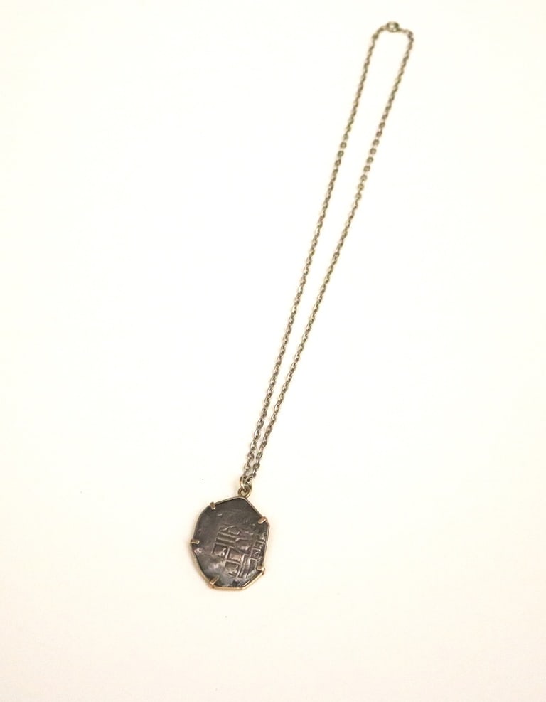 SPANISH SILVER PIECE-OF-EIGHT IN CONFORMING YELLOW GOLD ASYMMETRICAL FRAME, - 1 1/2" x 1 1/16".: SPANISH SILVER PIECE-OF-EIGHT IN CONFORMING YELLOW GOLD ASYMMETRICAL FRAME. - 1 1/2" x 1 1/16".