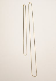 TWO BRIGHT-POLISHED YELLOW GOLD CHAIN NECKLACES.