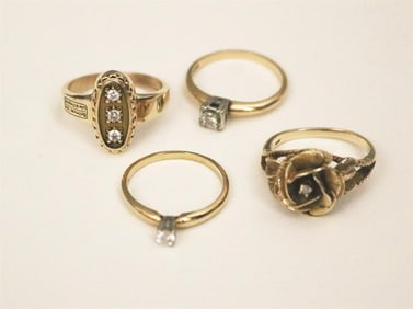 FOUR DELICATE YELLOW GOLD AND DIAMOND RINGS.