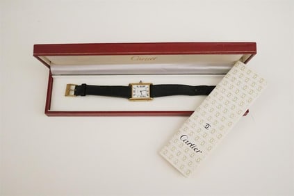 LADY'S CARTIER YELLOW GOLD PLATED TANK WATCH WITH BLACK LEATHER STRAP. circa 1976.