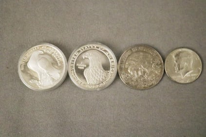 FOUR ASSORTED SILVER COINS.