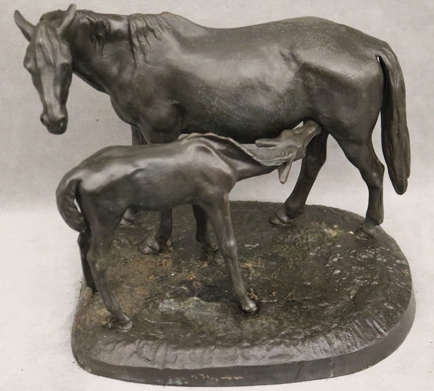 STANDING HORSE AND FOAL SCULPTURE. - (approximate) Height: 11.5 inches; Width:14.5 inches.: STANDING HORSE AND FOAL SCULPTURE. Bronze or likely cast iron sculpture depicts a mother horse feeding her foal, both standing on a natural ground base; possibly signed on the base and marked on the u