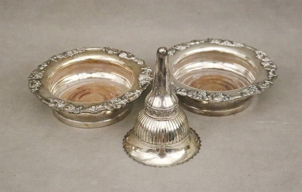 PAIR SILVER-ON-COPPER WINE COASTERS AND A SILVER-PLATED WINE FUNNEL. Coasters have relief grapevine: PAIR SILVER-ON-COPPER WINE COASTERS AND A SILVER-PLATED WINE FUNNEL. Coasters have relief grapevine serpentine borders; funnel has vermeil interior - Center, D: 7 in.