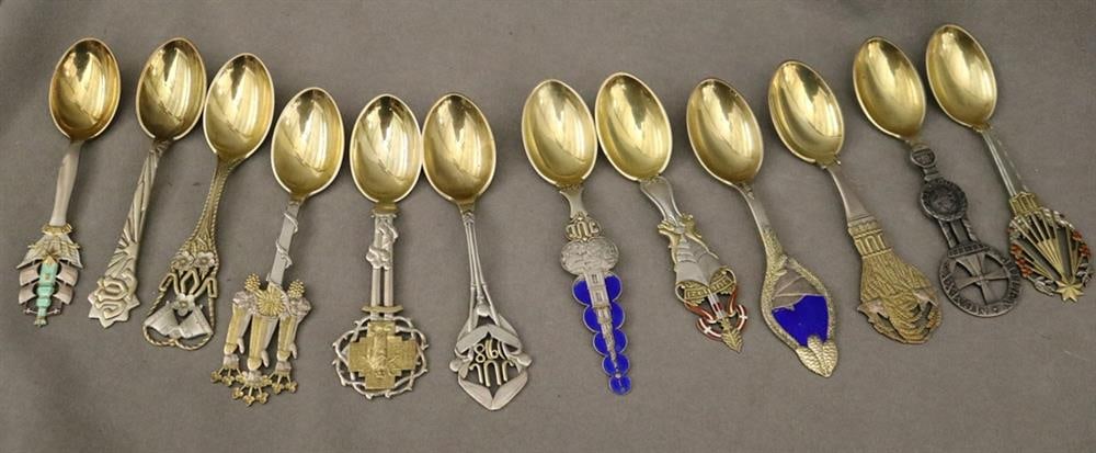 SET 12 DANISH STERLING SILVER CHRISTMAS SPOONS BY A. MICHELSEN, COPENHAGEN. early 20th century,. -: SET 12 DANISH STERLING SILVER CHRISTMAS SPOONS BY A. MICHELSEN, COPENHAGEN. early 20th century,. Various terminal motifs with vermeil accents; some with enamel decoration; vermeil bowls. Commemorating