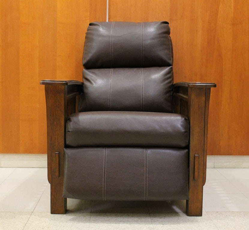 ARTS & CRAFTS MOVEMENT STYLE OAK, SLAT-SIDED ARM CHAIR WITH BROWN PEBBLED LEATHER BACK AND SEAT: ARTS & CRAFTS MOVEMENT STYLE OAK, SLAT-SIDED ARM CHAIR WITH BROWN PEBBLED LEATHER BACK AND SEAT CUSHIONS. Mechanically extending foot rest. - W" 33 3/4 in.