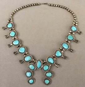 SOUTHWEST NATIVE AMERICAN STERLING SILVER AND TURQUOISE SQUASH BLOSSOM NECKLACE. - L: 25 in.