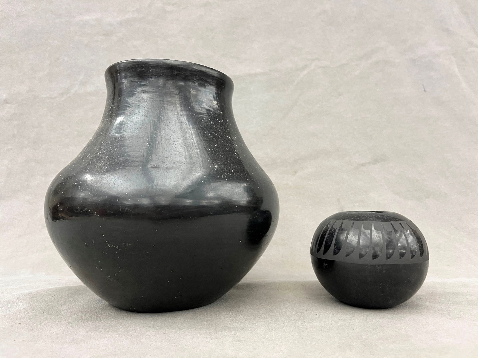 TWO SIGNED LUPITA MARTINEZ AND PAULINE MARTINEZ BLACK-ON-BLACK POTTERY FROM THE SAN ILDEFONSO PUEBLO: TWO SIGNED LUPITA MARTINEZ AND PAULINE MARTINEZ BLACK-ON-BLACK POTTERY FROM THE SAN ILDEFONSO PUEBLO IN NEW MEXICO. Two signed LUPITA MARTINEZ and PAULINE MARTINEZ black-on-black pottery from the San
