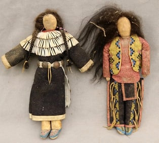 TWO APSAALOOKE (CROW) BEADED BUFFALO HIDE DOLLS. - Height: 11 inches.