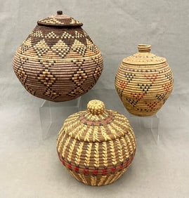 THREE ASSORTED NATIVE AMERICAN LIDDED COILED OLLA BASKETS, - Height (tallest): 12 inches.