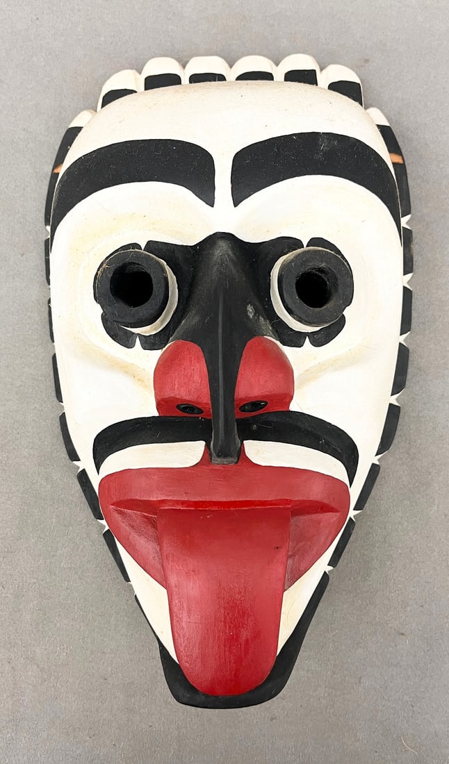 SIGNED R. JAGO ECHO MASK OR A XWIXWI (KWE-KE) MASK, - Height: 12 inches.: SIGNED R. JAGO ECHO MASK OR A XWIXWI (KWE-KE) MASK. Kwakwaka'wakw mask, specifically identified as an Echo Mask or a Xwixwi (Kwe-Ke) Mask. It is predominantly painted in a white color, has bulging eye