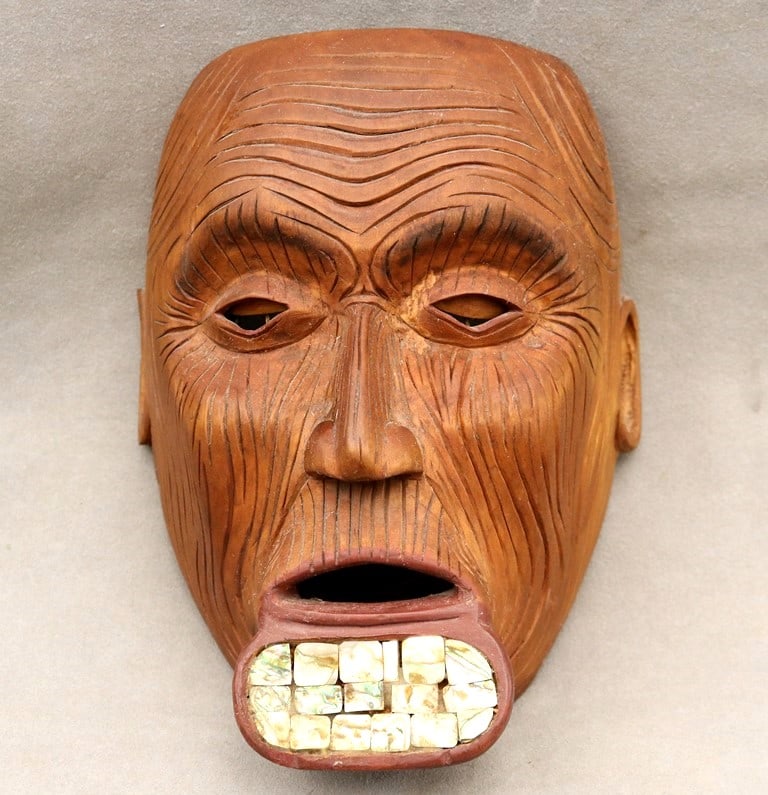 PACIFIC NORTHWEST COAST OLD PERSON TLINGIT MASK, - Height: 10.5 inches.: PACIFIC NORTHWEST COAST OLD PERSON TLINGIT MASK. Hand carved mask of an old person with a deep, expressive carvd highly stylized face. The mask features large, round eyes, the exaggerated deep wrinkle