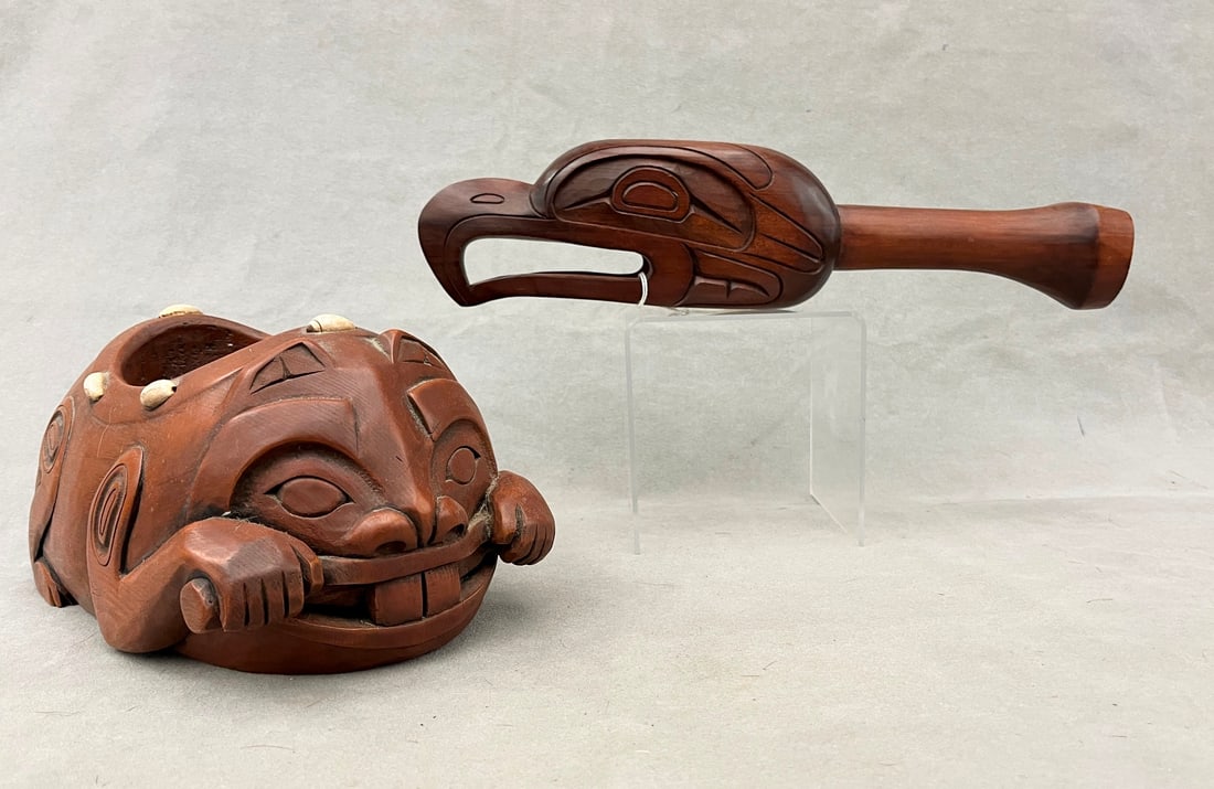 TWO PACIFIC NORTHWEST COAST BOWL AND RAVEN RATTLE, - Length (of the rattle): 15.5 inches.: TWO PACIFIC NORTHWEST COAST BOWL AND RAVEN RATTLE. Artist signed rattle Capilano Reserve (North Vancouver, BC) carver JIM CHARLIE. The carved Bowl or Container (Left) represents a specific mythologica