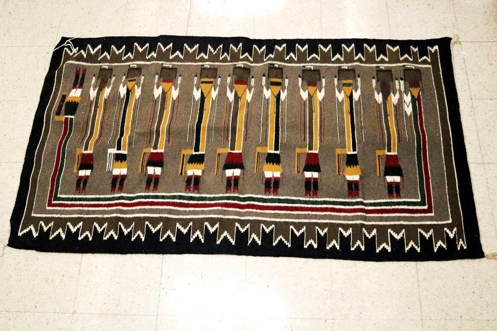 NAVAJO YEI RUG,: NAVAJO YEI RUG. Vintage rug with a recognizable type of weaving known as a Navajo Yei Rug (or a weaving inspired by this specific Navajo tradition). The central subject is a row of highly stylized, el
