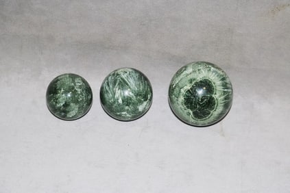 THREE SPHERICAL SHIVA LINGA STONES.