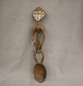 CONGOLESE BWAMI SOCIETY LEGA THREE FACED SPOON. - Length: 20.5 inches.