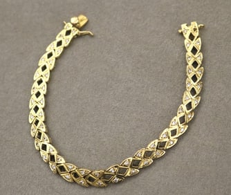 YELLOW GOLD AND DIAMOND FLEXIBLE-LINK BRACELET. - L: 7 1/4 in. W: 1/4 in. Gross wt. 12 dwt.