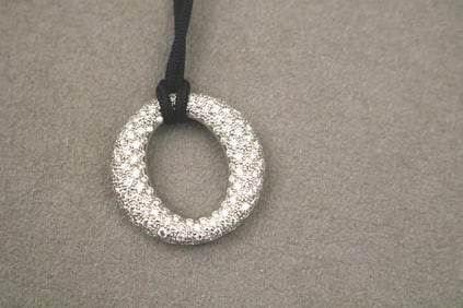 TIFFANY & CO. ELSA PERETTI PLATINUM AND DIAMOND "SEVILLANCE" PENDANT SUSPENDED ON BLACK SILK CORD,