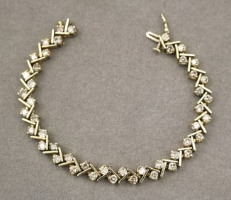 14K YELLOW GOLD AND DIAMOND FLEXIBLE-LINK BRACELET. - L: 7 1/4 in. W: 1/4 in. Gross wt. 14 dwt.