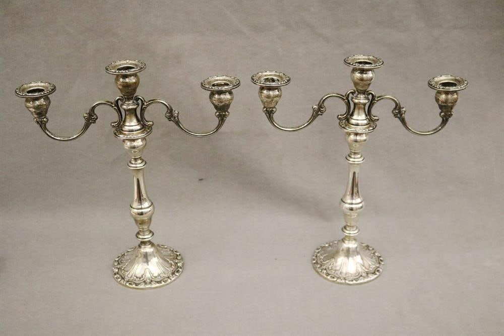 PAIR GORHAM CO. WEIGHTED STERLING SILVER THREE-LIGHT CANDELABRA CONVERTIBLE TO SINGLE CANDLESTICKS.: PAIR GORHAM CO. WEIGHTED STERLING SILVER THREE-LIGHT CANDELABRA CONVERTIBLE TO SINGLE CANDLESTICKS. Design no. 750. Baluster-form with relief scrollwork decoration. - H: 13 in. Gross wt 56 troy oz.