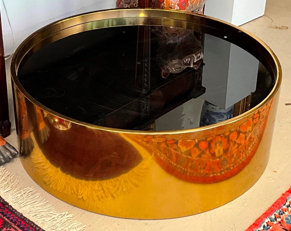 JONATHAN ADLER BRASS-FRAMED DRUM-FORM "ALPHAVILLE" COCKTAIL TABLE WITH BLACK GLASS TOP. - H: 13 in. (1 of 4)