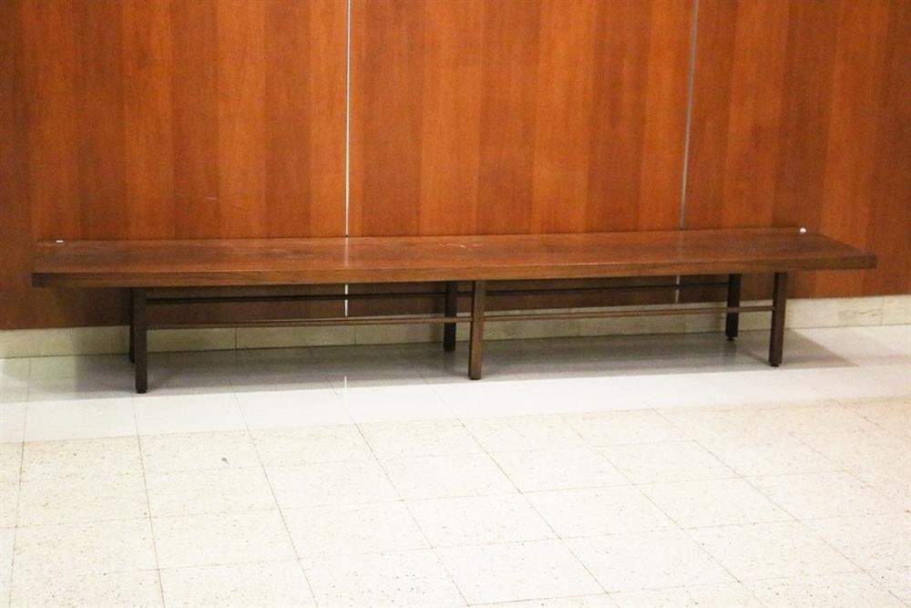 MID-CENTURY MODERN MILO BAUGHMAN FOR THAYER COGGIN WALNUT SLAB-TOP LOW RECTANGULAR TABLE. Six: MID-CENTURY MODERN MILO BAUGHMAN FOR THAYER COGGIN WALNUT SLAB-TOP LOW RECTANGULAR TABLE. Six squared legs joined by rod stretchers. - H: 14 1/2 in. L: 106 in. W: 20 in.