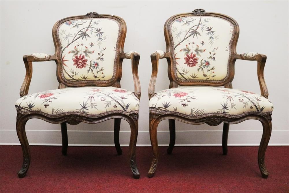 SET FOUR LOUIS XV CARVED FRUITWOOD UPHOLSTERED FAUTEUILS EN CABRIOLE. Floral crests; floral cotton: SET FOUR LOUIS XV CARVED FRUITWOOD UPHOLSTERED FAUTEUILS EN CABRIOLE. Floral crests; floral cotton upholstered back panels; seats and arm rests.