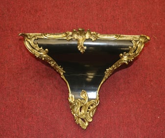 LOUIS XV STYLE GILT EBONIZED WALL-MOUNTED BRACKET FOR BRACKET CLOCK, 19th century. - H: 15 in.