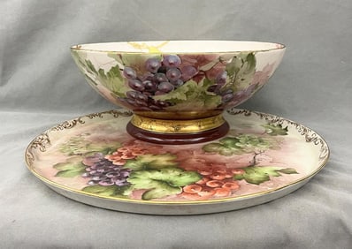 EARLY 20TH CENTURY SIGNED HAND-PAINTED LIMOGES CHINA PUNCH BOWL WITH CIRCULAR UNDERTRAY.