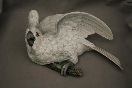 PAINTED CERAMIC WALL POCKET MODELED AS FIGURE OF WHITE BIRD PERCHED ON BRANCH IN STYLE OF MEISSEN.