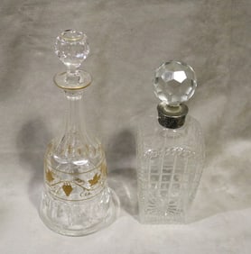 TWO VINTAGE COLORLESS CUT CRYSTAL DECANTERS WITH STOPPERS.