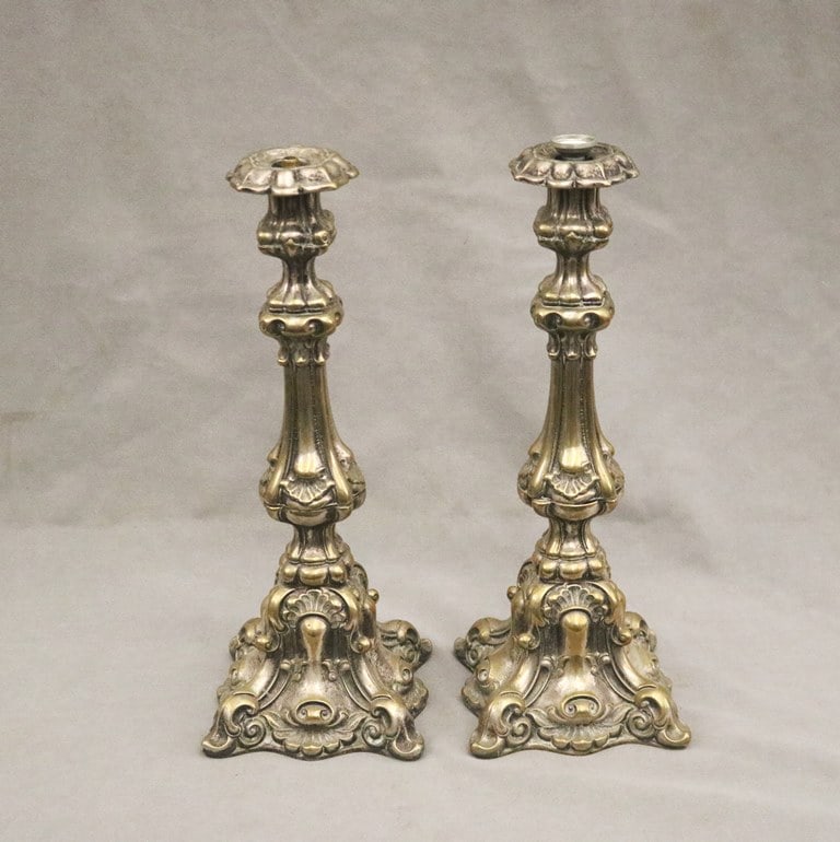 PAIR SILVERED BRASS BALUSTER-FORM CANDLESTICKS WIRED FOR ELECTRCITY. 19th century. - H: 15 1/2".: PAIR SILVERED BRASS BALUSTER-FORM CANDLESTICKS WIRED FOR ELECTRCITY. 19th century. High-relief cast scroll-and-shell decoration. - H: 15 1/2".