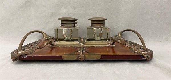 ART NOUVEAU BRASS-MOUNTED WOODEN STANDISH WITH PAIR SQUARE-SIDED COLORLESS CRYSTAL BOTTLES. - W: 13