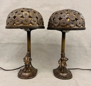 PAIR CHOCOLATE BROWN PATINATED BRONZE FIGURAL TABLE LAMPS WITH DOMED FLORAL SHADES. early 20th