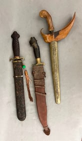 THREE ASSORTED ASIAN/MID-EASTERN SHORT SWORDS IN SHEATHS, late 19th-early 20th century. - Longest,