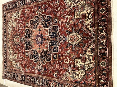 PERSIAN HERIZ RUG. Moth damage at corner.