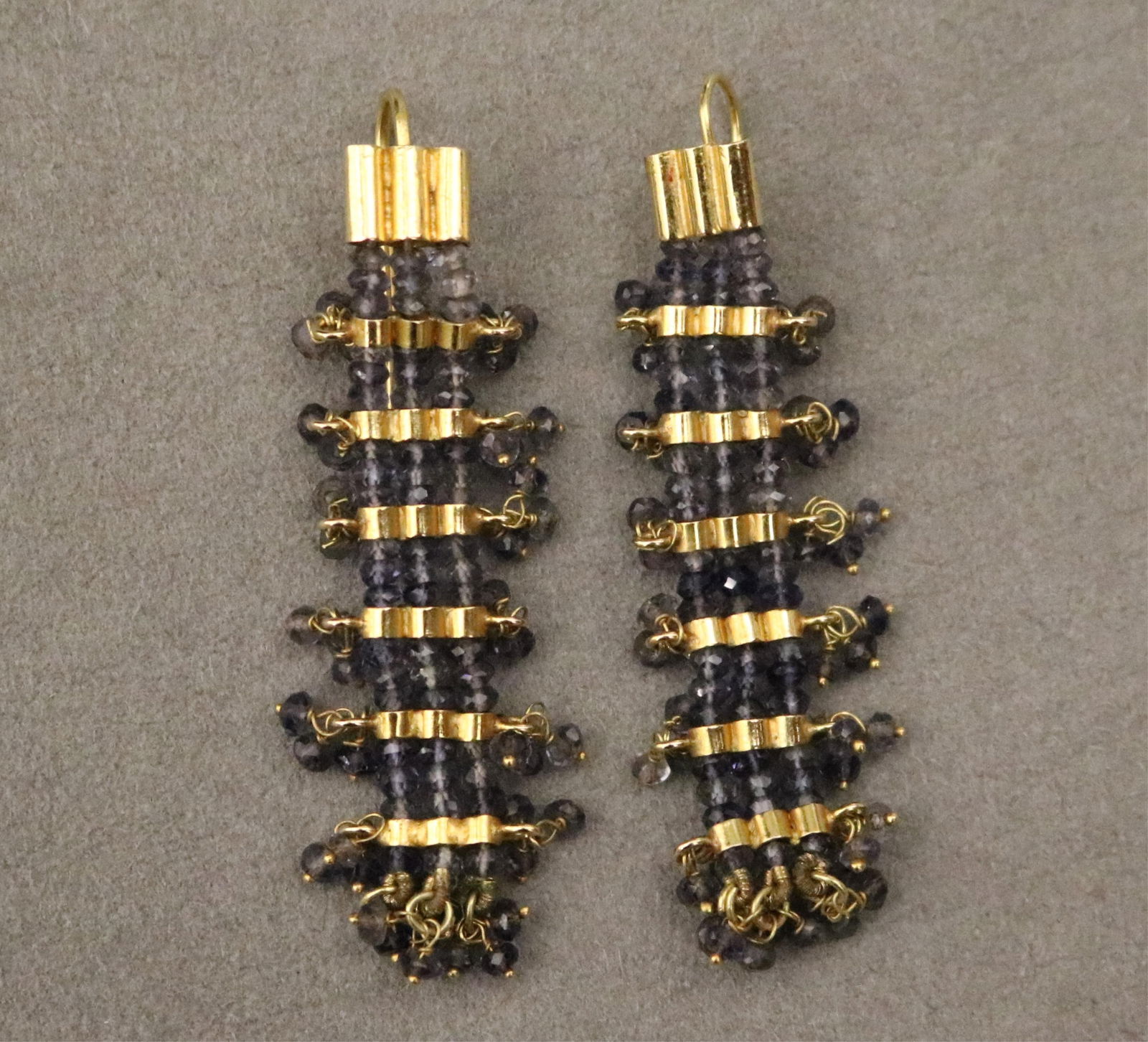 PAIR YELLOW GOLD AND PALE SAPPHIRE BEAD FLEXIBLE DANGLE EARRINGS: PAIR YELLOW GOLD AND PALE SAPPHIRE BEAD FLEXIBLE DANGLE EARRINGSNumerous faceted beads spaced by horizontal rows of shaped gold bars; wire backs.L: 2 1/4 in.