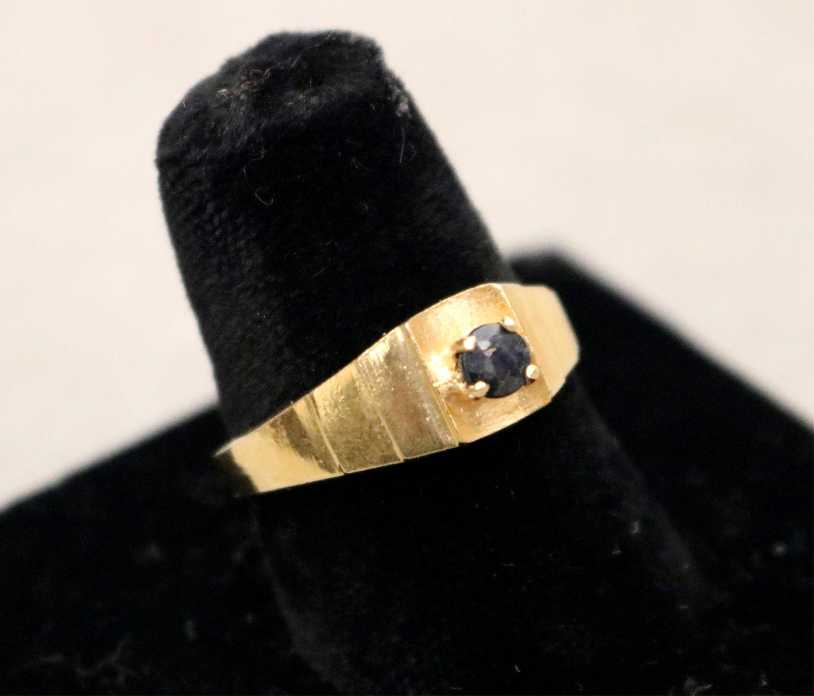 EGYPTIAN GOLD TAPERING BAND WITH RAISED PRONG-HELD ROUND SAPPHIRE. Ring size: 8. Wt.: 2 dwt.: EGYPTIAN GOLD TAPERING BAND WITH RAISED PRONG-HELD ROUND SAPPHIRE.Ring size: 8. Wt.: 2 dwt.
