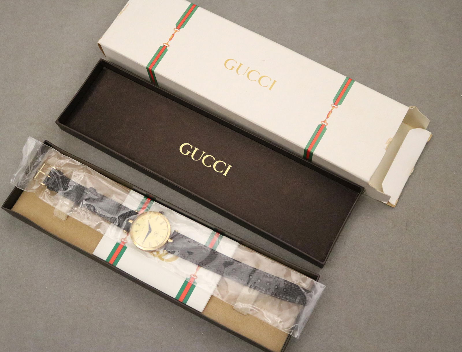 GUCCI GOLD-PLATED AND ENAMEL FASHION WATCH WITH BLACK LIZARD-TEXTURED STRAP. (1 of 11)