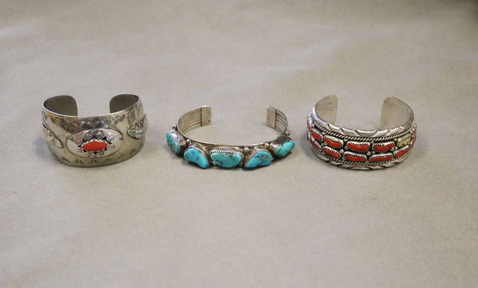 THREE AMERICAN INDIAN SILVER CUFF BRACELETS VARIOUSLY SET WITH CORAL AND TURQUOISE CABOCHONS. (1 of 5)