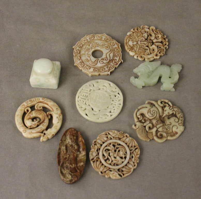 GROUP NINE CHINESE STONE CARVINGS. Including four seals and five white stone amulets. Variously (1 of 2)