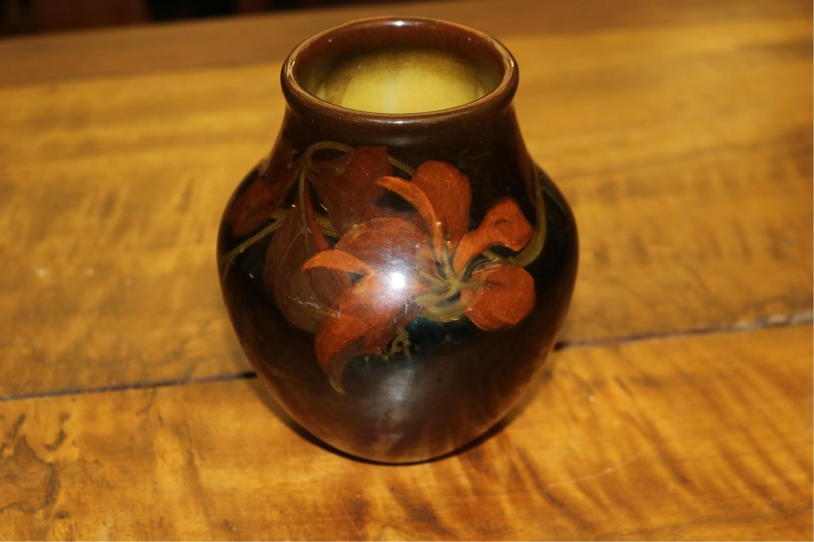 ARTIST-SIGNED ROOKWOOD BROWN GLAZED JAR HAND-PAINTED WITH RUST COLOR FLORAL DECORATION. Incised: ARTIST-SIGNED ROOKWOOD BROWN GLAZED JAR HAND-PAINTED WITH RUST COLOR FLORAL DECORATION. Incised artist's logo and date of "III"; numbered 914E. - Height: 5 1/4".