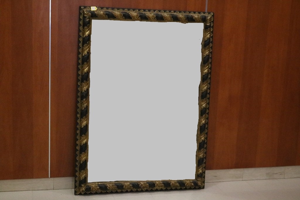 ITALIAN EBONIZED AND PARCEL-GILT RECTANGULAR WALL MIRROR, 19th century. - 56 1/2 in. x 41 1/2 in.: ITALIAN EBONIZED AND PARCEL-GILT RECTANGULAR WALL MIRROR, 19th century. Molded black frame wrapped with gilt acanthus leaves - 56 1/2 in. x 41 1/2 in.