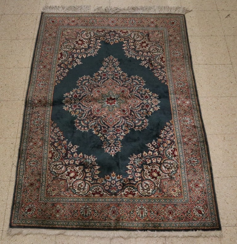 KERMAN PATTERN HAND-WOVEN WOOL AREA RUG. Central medallion on dark blue field with floral motifs; (1 of 8)