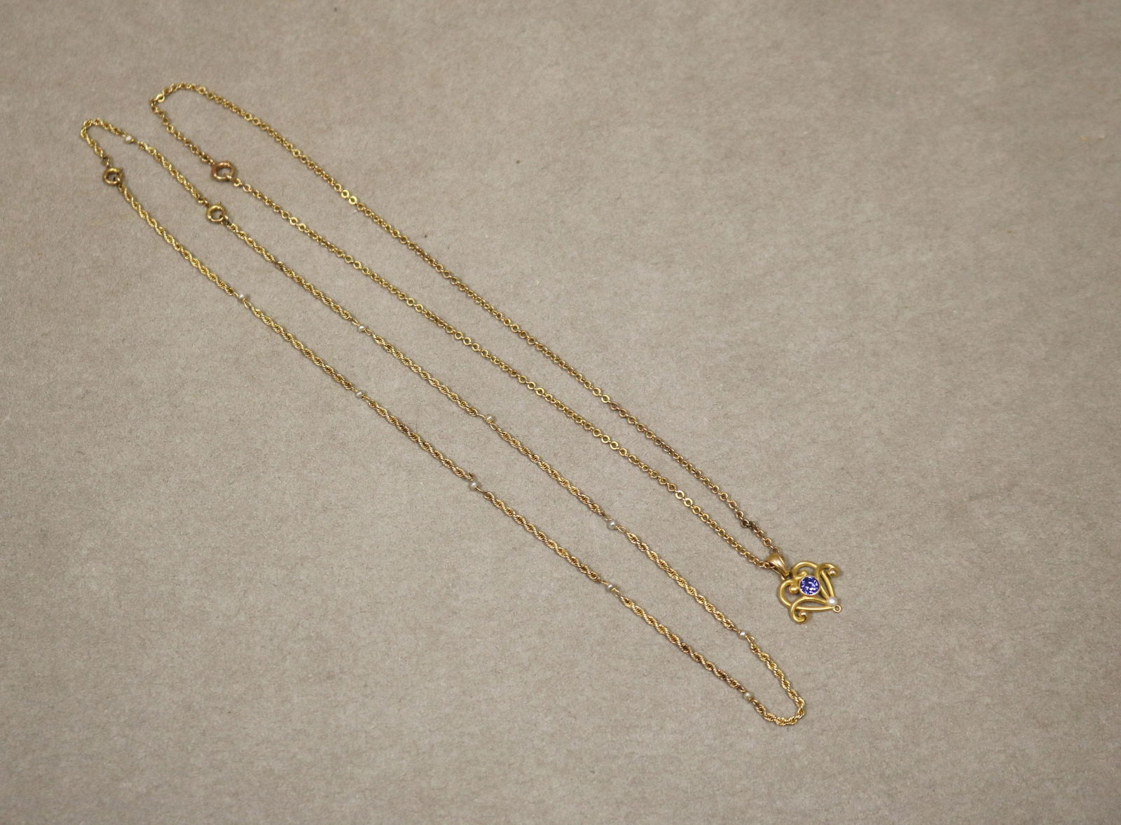 TWO EDWARDIAN 10K YELLOW GOLD DELICATE FLEXIBLE-LINK CHOKERS - Total wt.: 5 dwt..: TWO EDWARDIAN 10K YELLOW GOLD DELICATE FLEXIBLE-LINK CHOKERS One, spaced with ten seed pearls, L: 18 in. Other, round-link chain suspending 14K yellow gold openwork heart-shape lavaliere set with roun