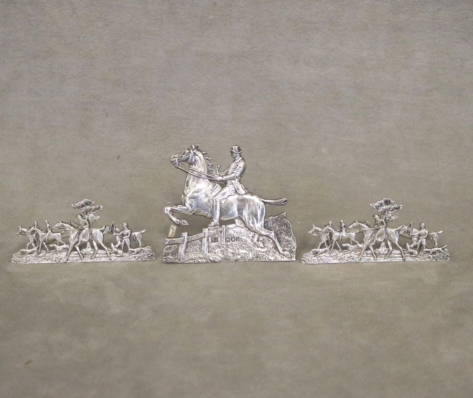 THREE ENGLISH SILVER PLACECARD HOLDERS CAST AS HUNTING SCENES - Largest, H: 2 3/4 in. Wt. 2.6 troy: THREE ENGLISH SILVER PLACECARD HOLDERS CAST AS HUNTING SCENES Largest, H: 2 3/4 in. Wt. 2.6 troy oz.