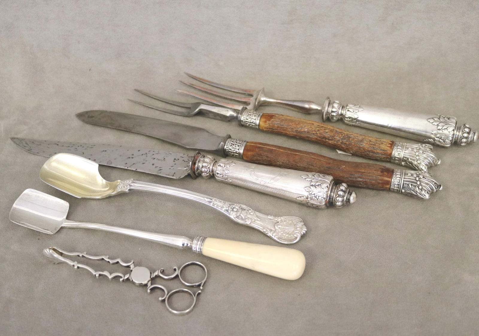 SEVEN ASSORTED SILVER TABLE ITEMS late 19th-early 20th century - .: SEVEN ASSORTED SILVER TABLE ITEMS late 19th-early 20th century Including Tiffany & Co. stilton cheese scoop (3.6 troy oz.); Georgian stilton cheese scoop; pair hand-wrought sugar nips; and two pairs s