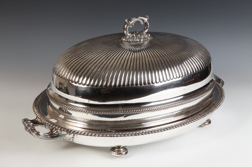 SILVER-ON-COPPER GEORGE III DOMED PLATTER COVER OVER OVAL WELL-AND-TREE PLATTER WITH HOT WATER: SILVER-ON-COPPER GEORGE III DOMED PLATTER COVER OVER OVAL WELL-AND-TREE PLATTER WITH HOT WATER CHAMBER. circa 1820. Retailed by Tonkin of Nantucket. Reeded cover with shaped removable handle; platter